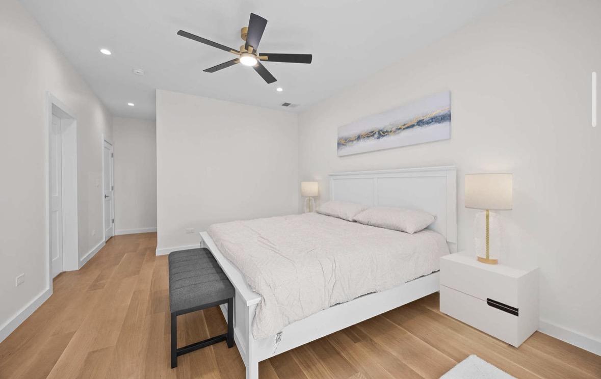 Bedroom with ceiling fan and recessed lighting