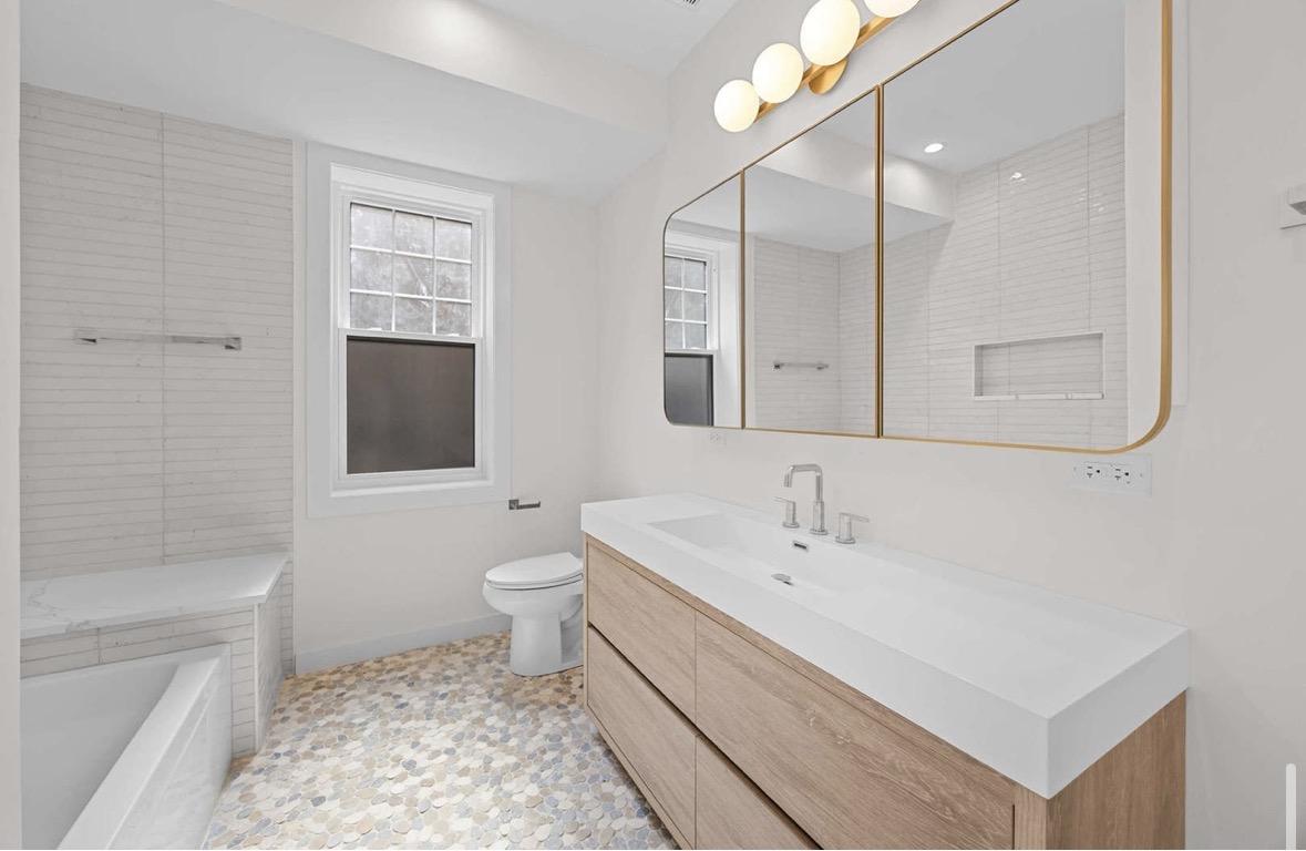 Modern bathroom with gold vanity light fixture